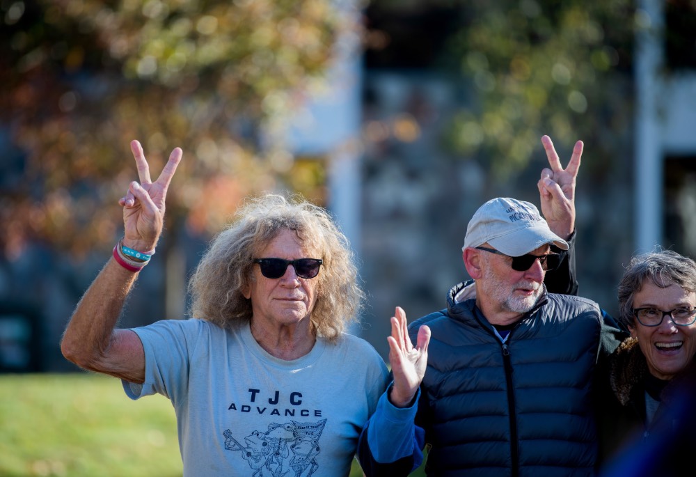 Group of people holding up 2 fingers